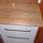 Kitchen cabinets and benchtops are clean and contemporary