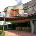 Driveway extends below extension and front deck