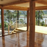 Open plan living area opening onto wrap-around deck