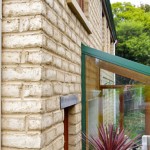 Mud-brick walls and glassed-in rear porch