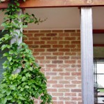 Verandah posts made from the roof trusses of a demolished warehouse.